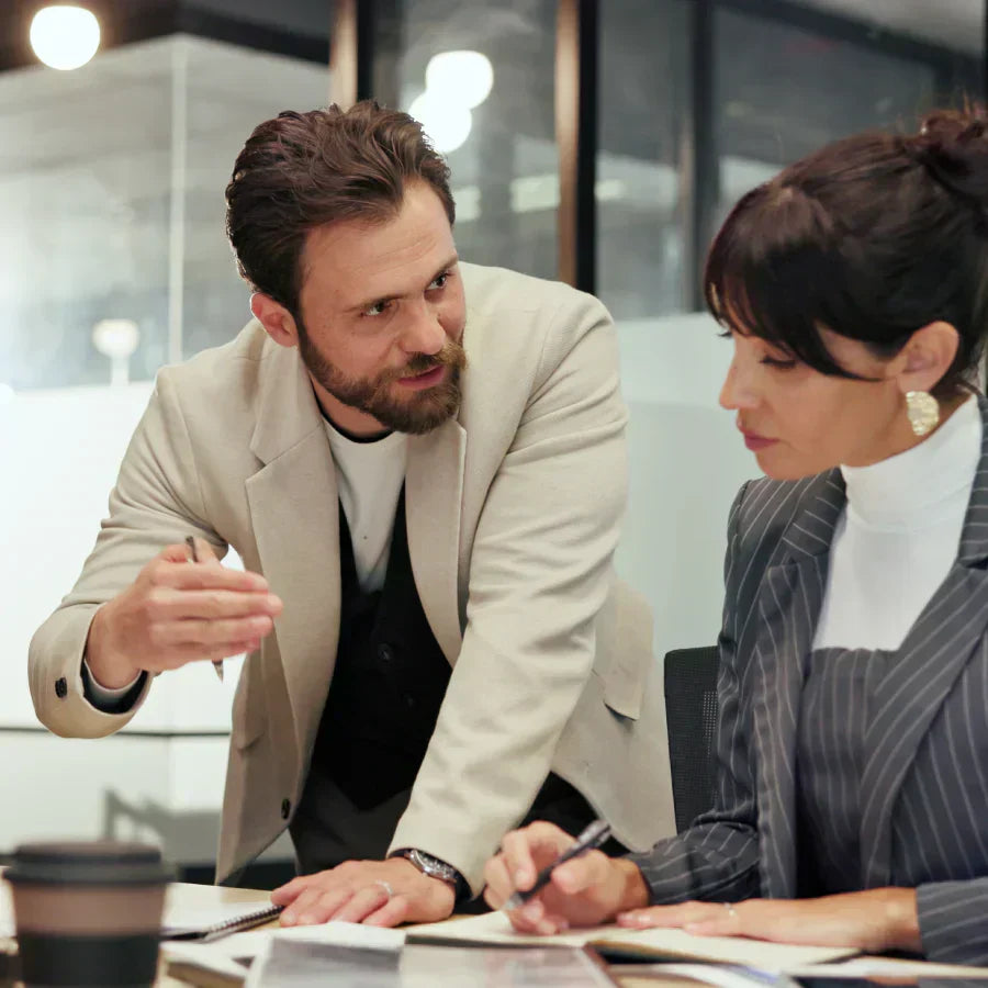 Two professionals collaborate in a meeting, capturing key insights with Plaud AI voice recorders.