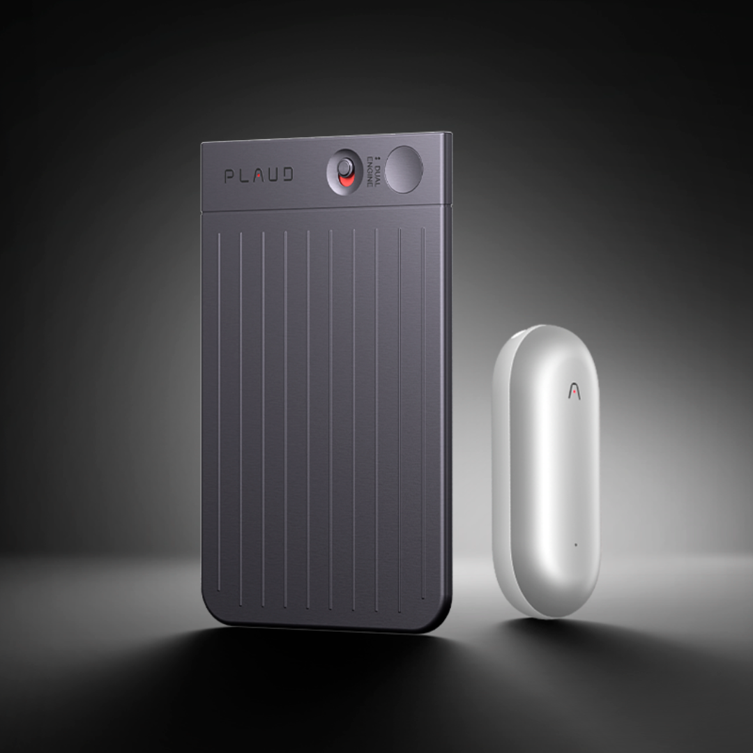 Black Plaud Note Pro with vertical ridges and silver Plaud NotePin capsule on a dark background.