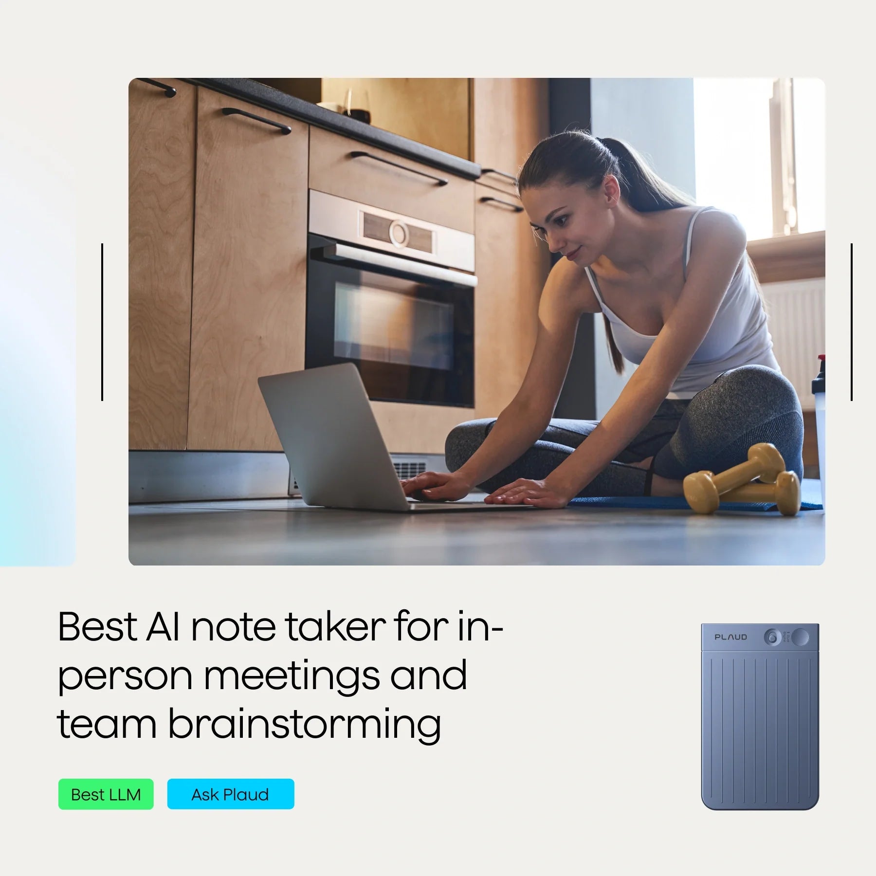 A person sitting on the floor with a laptop and a dumbbell in a kitchen setting.