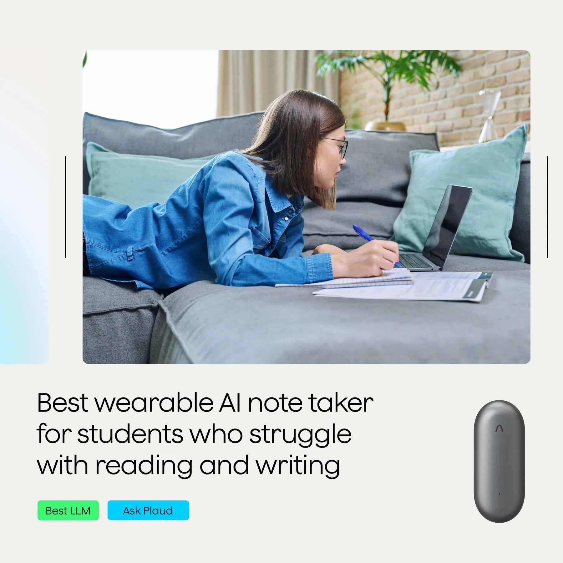 A student lying on a sofa, using a laptop and taking notes with a pen.