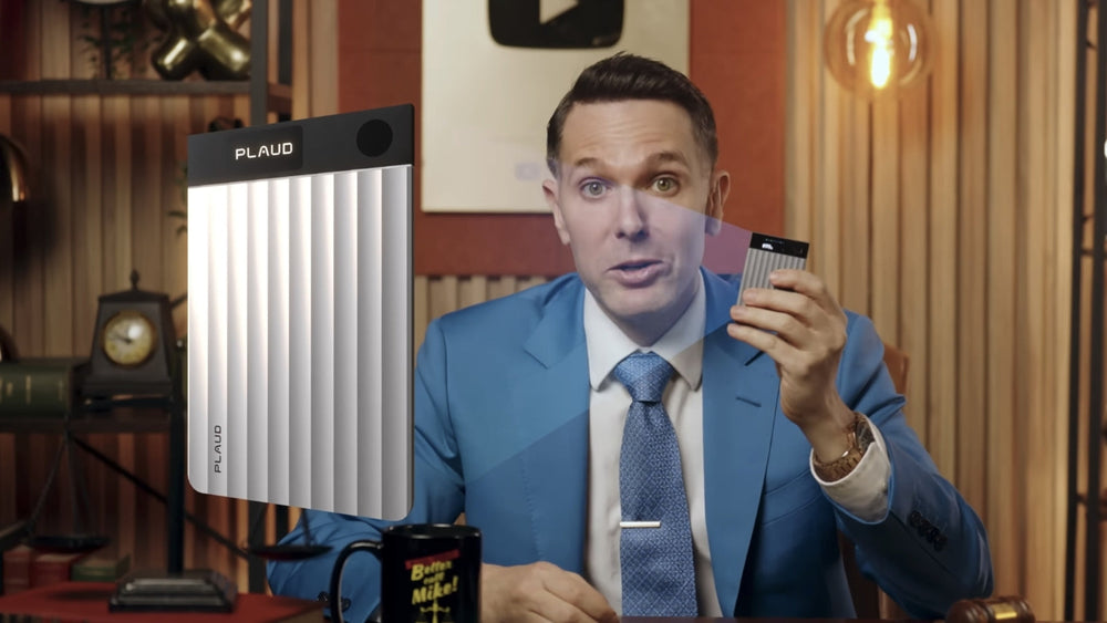 Man in blue suit holding a silver Plaud Note Pro, with a large product overlay on the left.