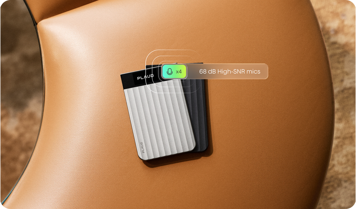 Silver and black Plaud Note Pro recorders rest on a tan leather surface, featuring text about their four 68 dB High-SNR microphones.