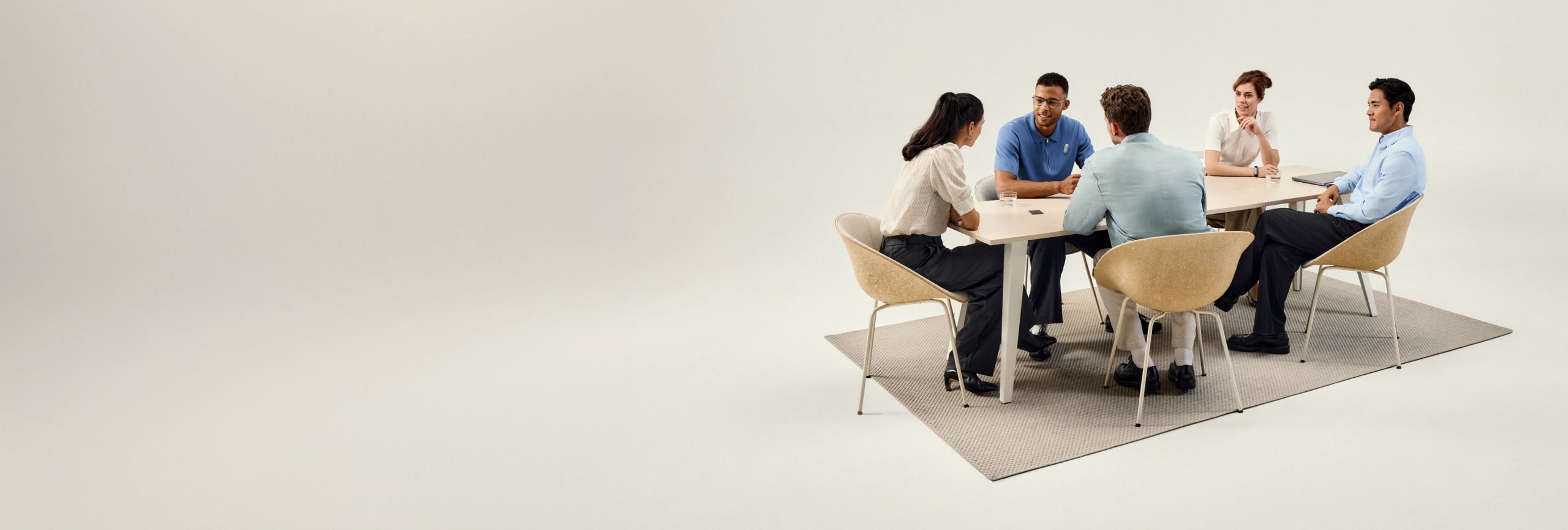 Five people in a meeting using a black Plaud AI voice recorder for notes.