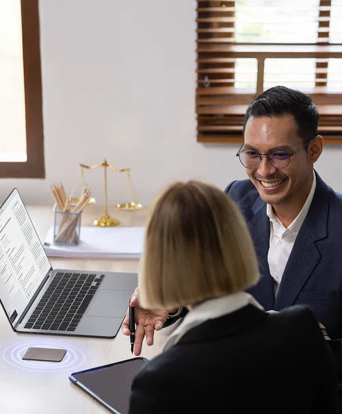A black Plaud Note recording a meeting between two professionals in an office.