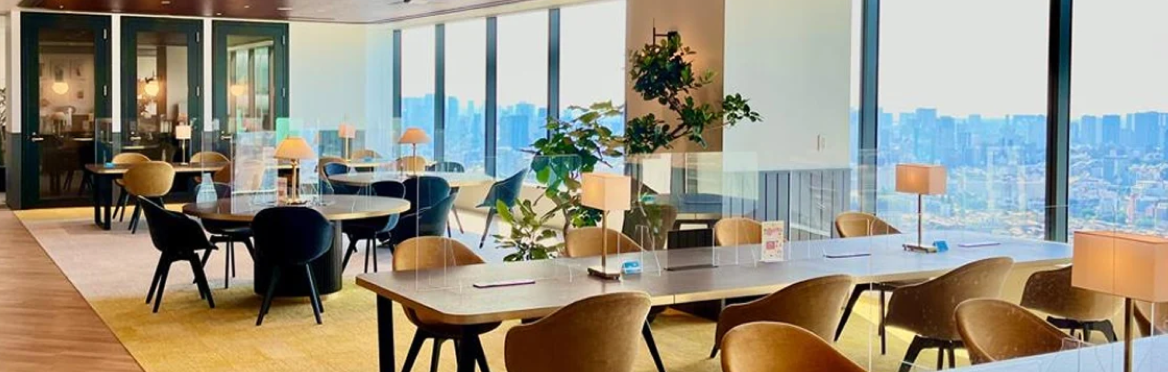 Modern office lounge with city views and Plaud AI voice recorders on tables, ready for professional meetings.