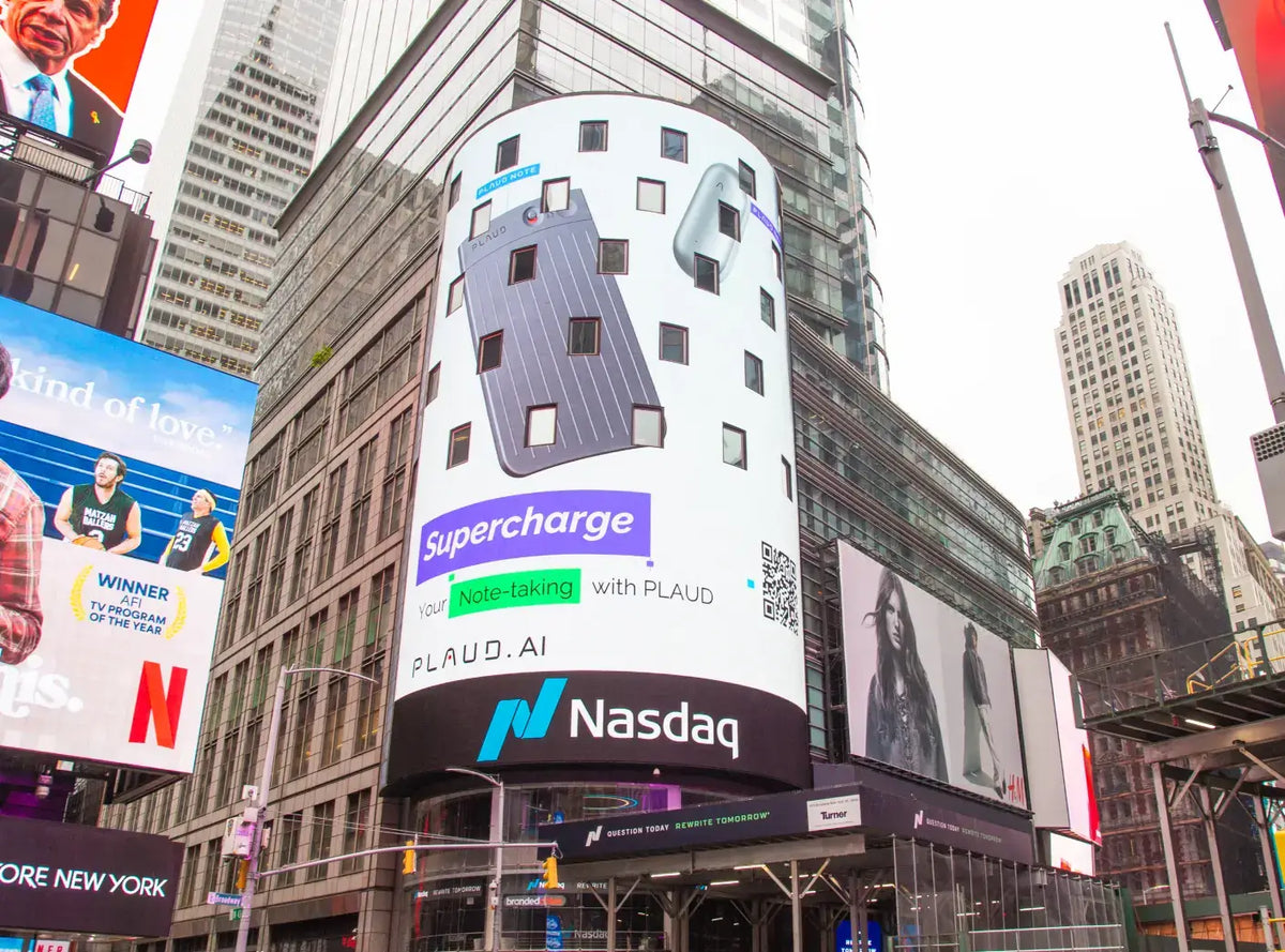 Plaud AI billboard in Times Square featuring the Plaud Note and Plaud NotePin on the Nasdaq building.